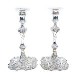 A pair of George III candlesticks, with shaped square detachable drip pans on waited cylindrical sco