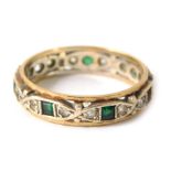 A 9ct gold eternity ring, set with design of white and green paste stones, set in white gold with a