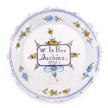 An 18thC French Faience commemorative plate, titled W Le Pere Duchene 1791, 22cm diameter. (AF)