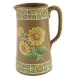A Victorian basalt relief moulded jug, decorated with sunflowers, etc., registration mark and indist