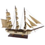 A scale model of a four masted sailing ship, with cream painted hull and rectangular base, 69cm wide