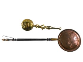 A Victorian engraved brass warming pan, with ebonised handle, 112cm long, and a 19thC pierced brass