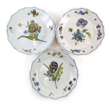 A 19thC La Rochelle Faience plate, decorated with flowers within a shaped border, 23cm wide, and two