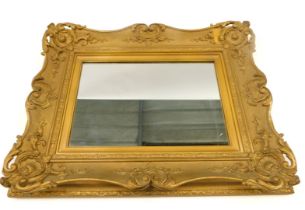 A gilt gesso rectangular wall mirror, the moulded frame decorated with shell, scrolls, etc., 73cm hi