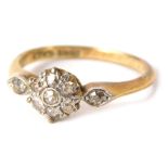 An 18ct gold and plat diamond cluster ring, the central cluster set with tiny diamonds in claw and r