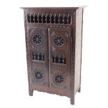 A 20thC French country made miniature armoire, with spindle turned and carved decoration, 46cm high,