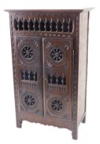 A 20thC French country made miniature armoire, with spindle turned and carved decoration, 46cm high,