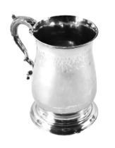 A George III silver tankard, of plain design with a leaf moulded handle, maker SD, London 1782,