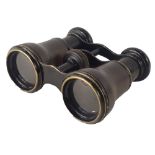 A pair of field glasses, each with a moulded and hatched rim, unmarked.