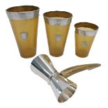 Three horn beaker, each with a silver rim and shield, together with a horn handled and stainless ste