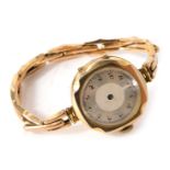 A 9ct gold cased ladies wristwatch, with silvered numeric dial, lacking hands, 2cm diameter, on expa