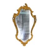 A gilt cartouche shaped wall mirror, 83cm x 51cm.