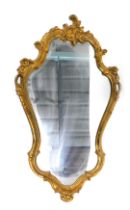 A gilt cartouche shaped wall mirror, 83cm x 51cm.