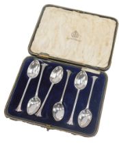 A cased set of six George V silver teaspoons, each with an art deco fanned top, on a plain bowl by E