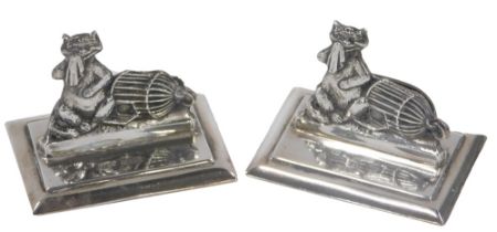 A pair of George V silver menu holder, each depicting novelty cat with cage and handkerchief, maker