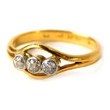 A 22ct gold three stone diamond dress ring, set with three old cut diamonds, in a rub over platinum