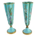 A pair of Victorian turquoise glass vases, each decorated with painted design of floral sprays, with