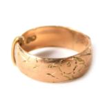 A 9ct gold wedding band, of hammered and etched buckle design, ring size L½, 3.4g all in.