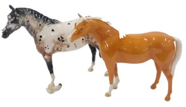 Two Beswick horses, comprising a tan horse, and an appaloosa, 19cm high. (2, AF)