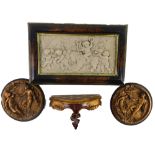 A Continental resin plaque, decorated with putti and a lion, a pair of similar plaques and a small V