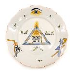 An 18thC French Faience Masonic related plate, decorated with various symbols, 23cm diameter.