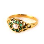 An emerald and cultured pearl dress ring, formed as a floral cluster with pierced and scroll outer b