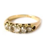 A 9ct gold dress ring, set with five channel set white stones, imitation diamonds, yellow metal stam