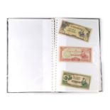 An album containing a collection of banknotes, to include rupees, cents, Yuan, etc. (1 album)