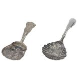 Two silver caddy spoons, comprising a shell patterned spoon bearing the initials IT, and a Victorian