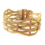 An Eastern inspired bracelet, of twist and rope twist decoration, set with rubies in rows of twos an