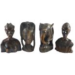 An African hardwood tribal carved bust, two similar busts and a carved elephant, embellished with bo