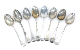 An associated set of eight Georgian silver old English pattern table spoons, all engraved to include