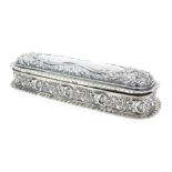 An Edward VII silver oblong dressing table box, with hinged lid, embossed decoration, 5oz, 20cm wide