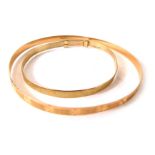 Two bangles, comprising a 9ct gold adjustable bangle, rubbed 5.5cm diameter, and an unmarked bangle