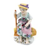 A continental porcelain figure, a girl on haystack with a crook, 9.5cm high.