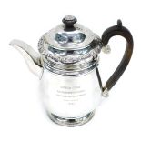 A Victorian silver teapot, with floral engraved rim, crested scroll wooden handle, London 1893, 32oz