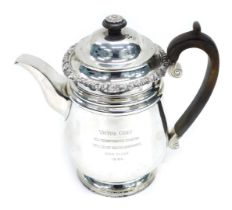 A Victorian silver teapot, with floral engraved rim, crested scroll wooden handle, London 1893, 32oz