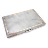 A George VI silver cigarette case, yellow gold banded engine turn design, with gilt interior, London