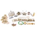 A group of silver plated wares, comprising two flower candle stands, a copper toast rack, letter ope