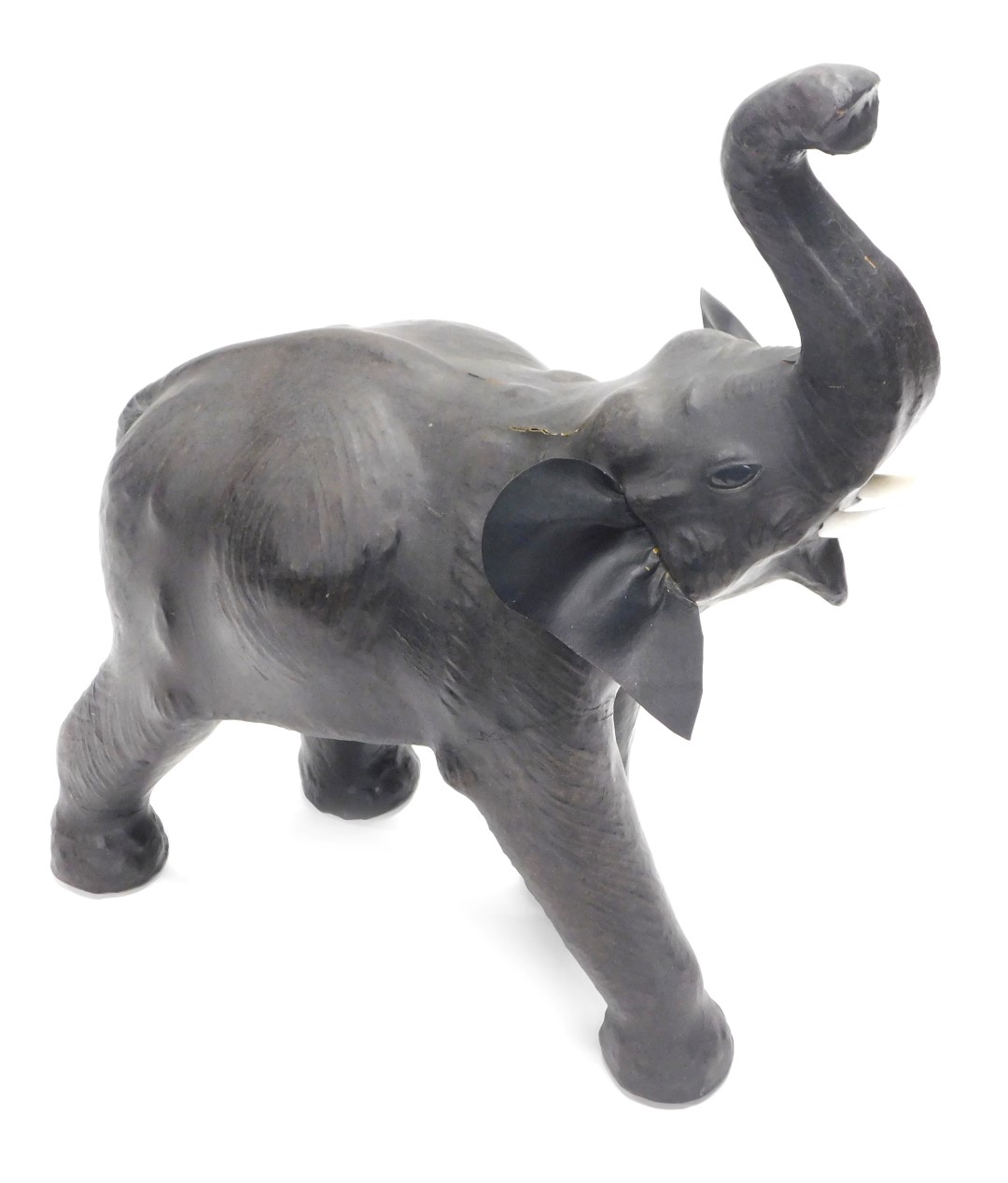 A large leather covered elephant, in the manner of liberty, with plastic tusks, 74cm high.