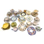 A large quantity of French Faience souvenir cups and saucers, to include Quimper, various designs, t