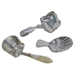 A George III silver tea caddy spoon, with shell shaped bowl, London 1909, and two others. (3)