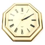 A Seiko quartz wall clock, with cream and gilt plastic case, 30cm wide.