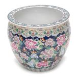 A 20thC Chinese porcelain fish bowl or jardiniere, decorated overall with flowers on a blue ground,