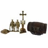 A scale brass model of a First World War tank, two brass figurines of soldiers with rifles, a cross,