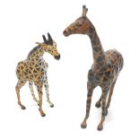 A painted brown leather covered figure of a giraffe, in a manner of liberty, 58cm high, and another