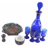 A blue glass liqueur set, comprising decanter and stopper, four glasses, blackcurrent carnival glass