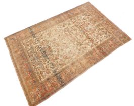 A Persian style rug, decorated with a tree of life style design, in iron red, blue, beige etc. on a