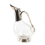 A novelty claret jug, formed as a duck with silver plated mount, 25cm high.