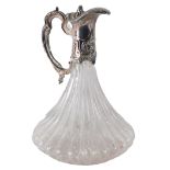 A pressed glass and silver plated claret jug, with thumb piece lift handle, on scroll base, with blu